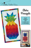 Cover photo of Aloha Pineapple quilt pattern showing the quilt in the rainbow and red, white and blue colorways